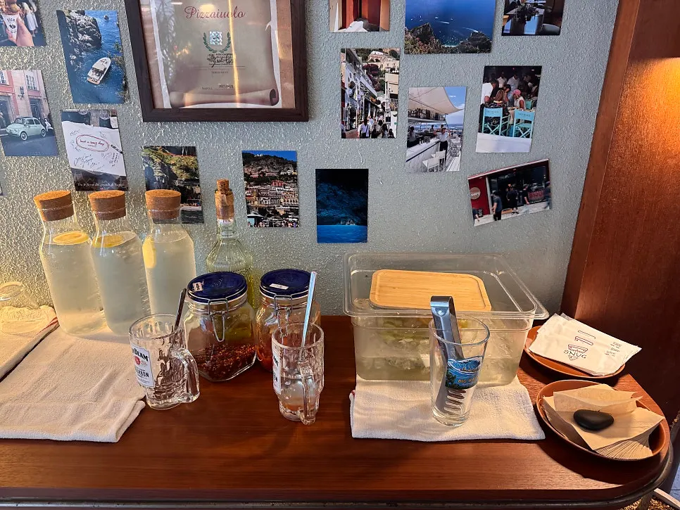 Small self-serve bar with lemon water and pickles