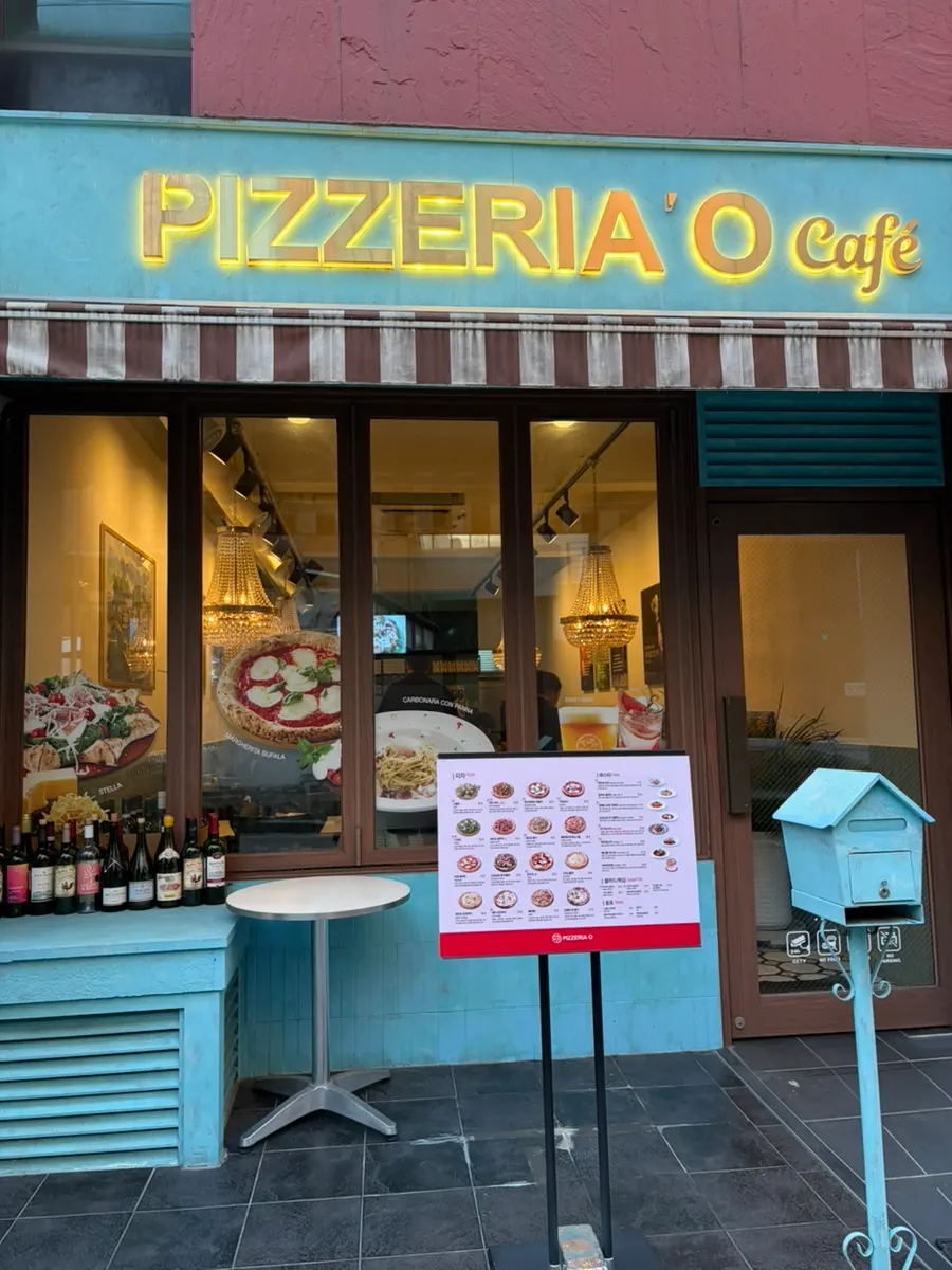 Sky-blue exterior of Pizzeria O Hapjeong Station near Hapjeong Station