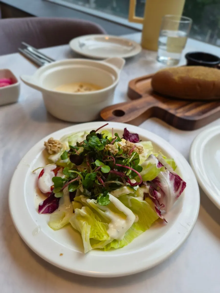 Salad, bread and soup included in the set spread on the table