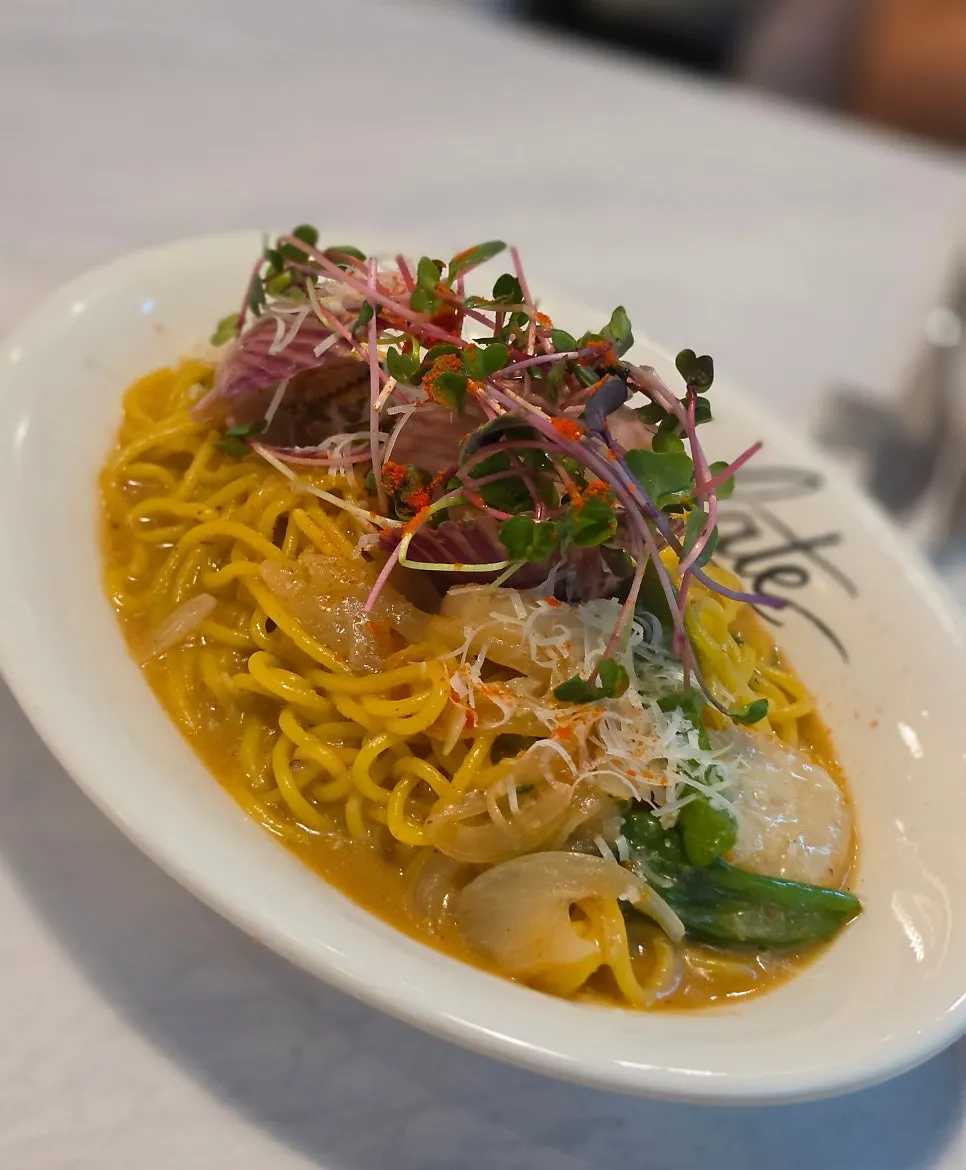 Scallop uni oil pasta topped with pink cockles