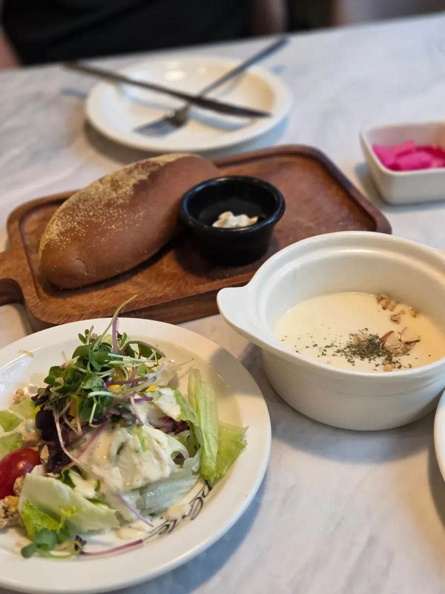 Set of pre-meal bread, soup, salad, and pickles