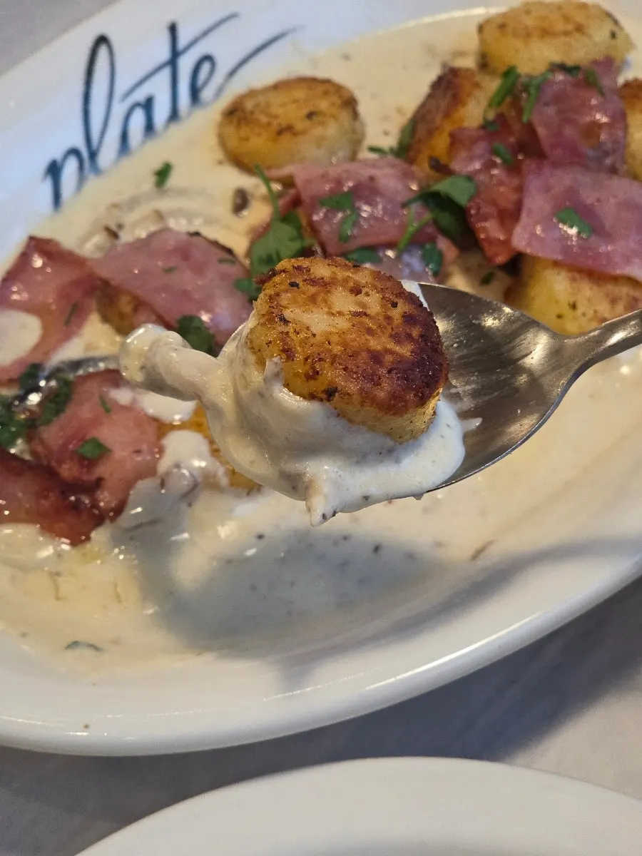 A single piece of gnocchi lifted on a fork