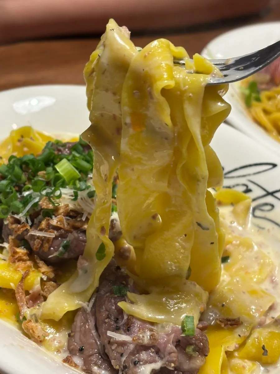 Thick pappardelle noodles in cream sauce