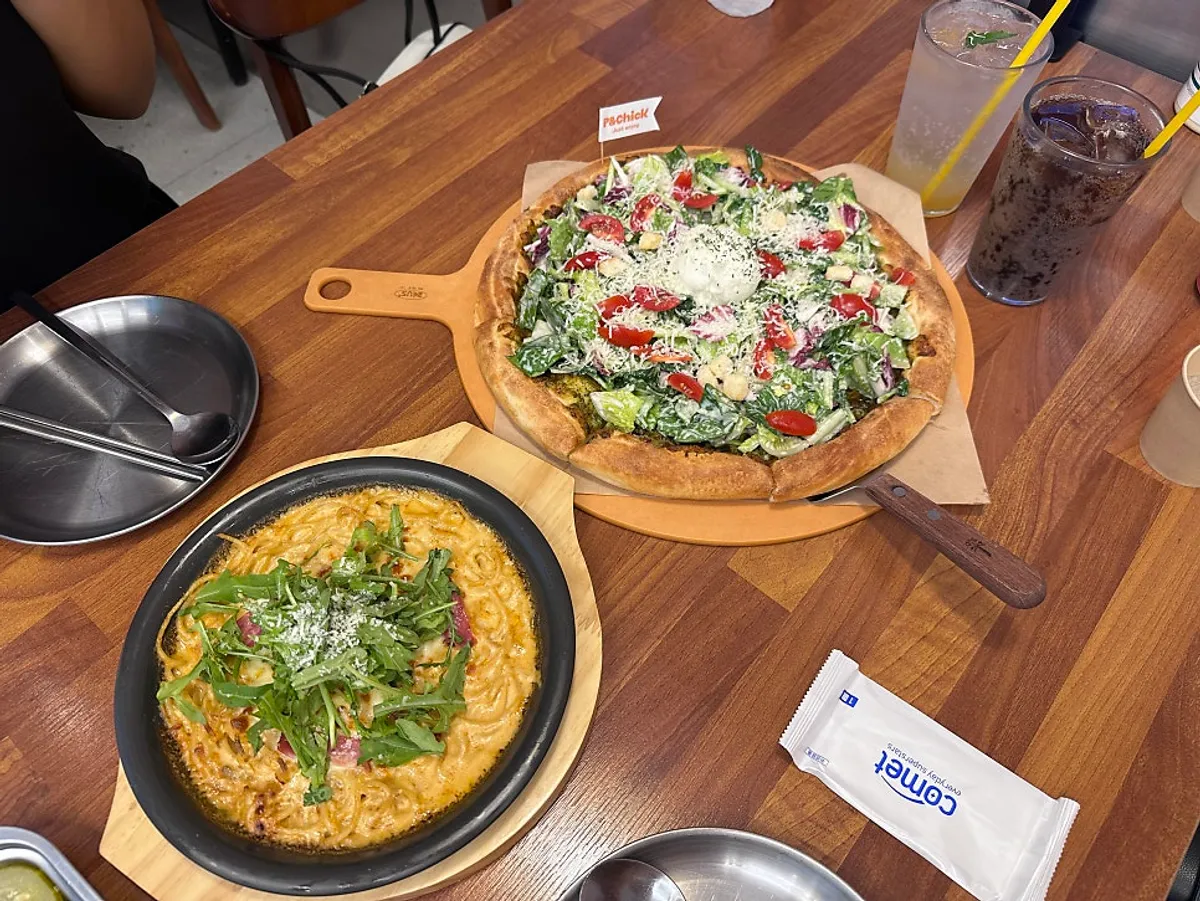 Basil Caesar Salad Pizza L and Toowoomba Oven Pasta on the table