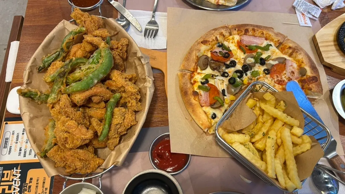 Pizza and boneless gochu fried chicken set together on the table
