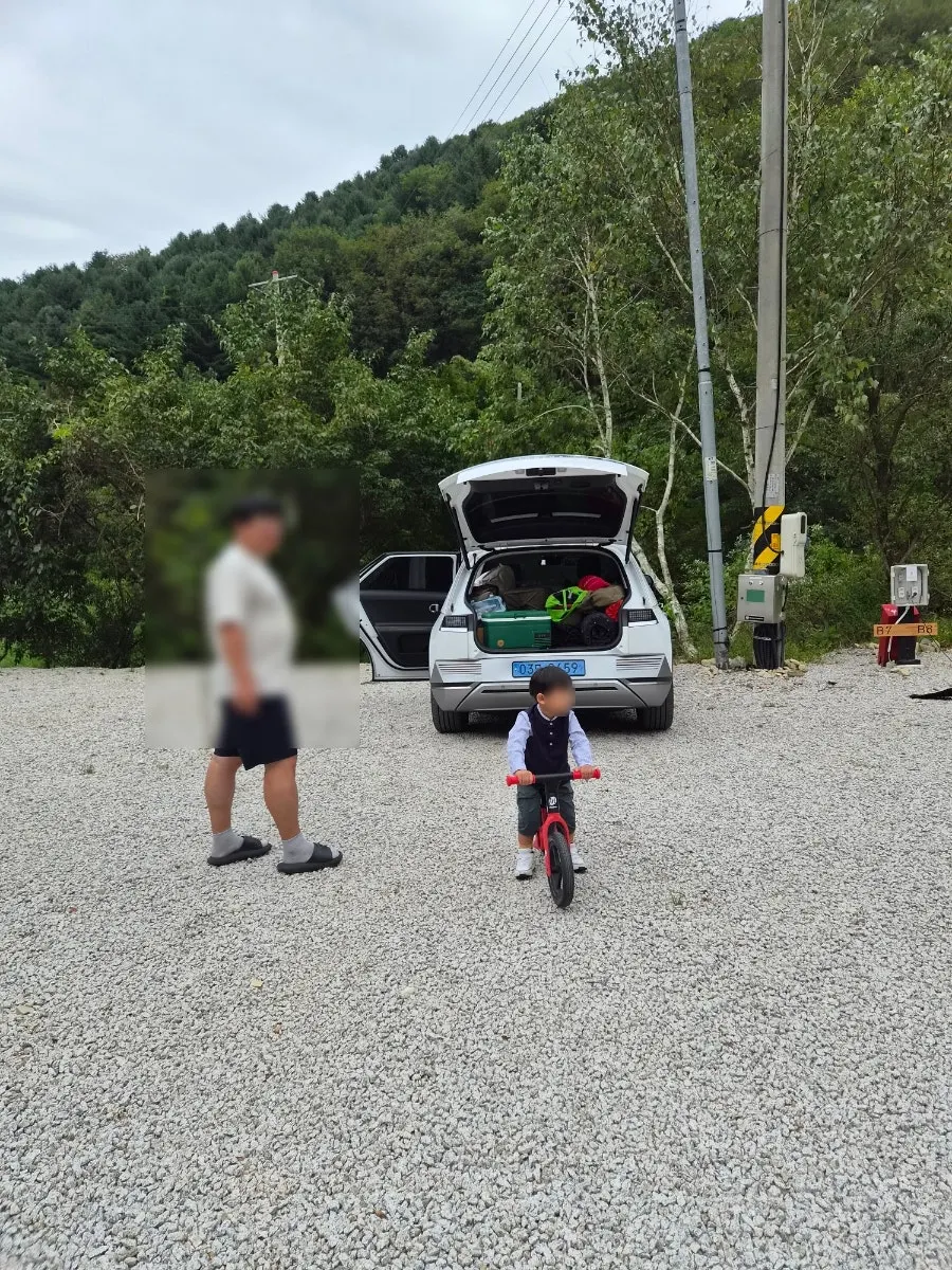A child riding a balance bike at the campground