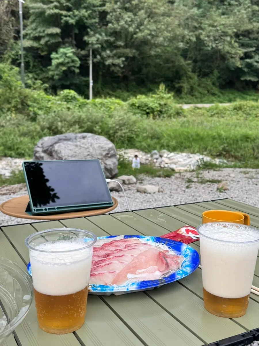 Dinner table with sashimi at the camping site