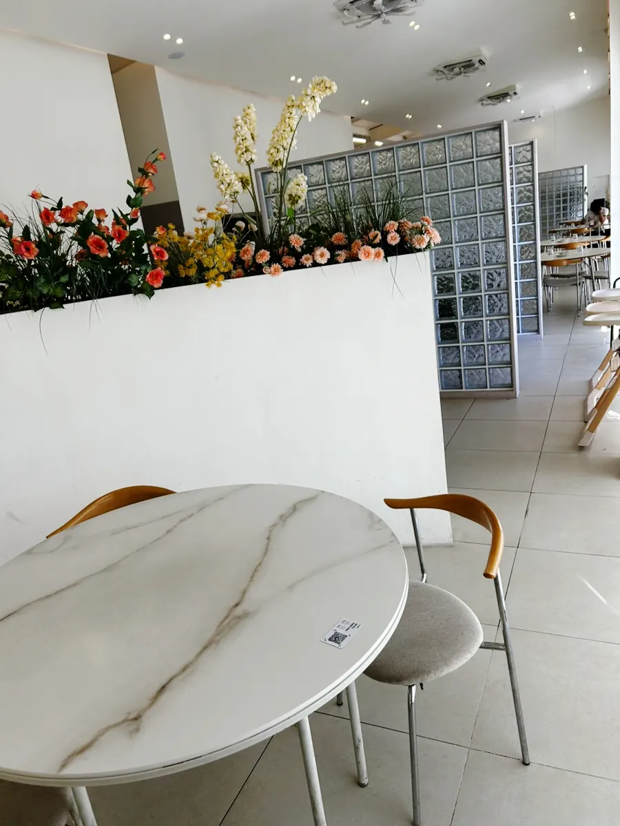 Eoneu Dal dining hall decorated with yellow flowers and potted plants