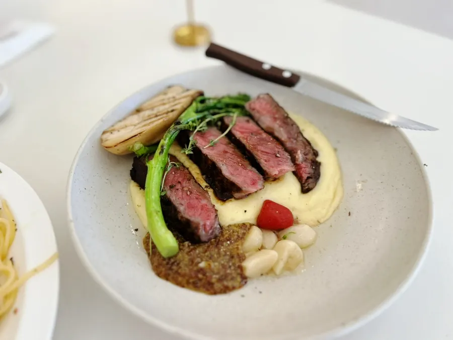Hanwoo striploin steak served over mashed potatoes