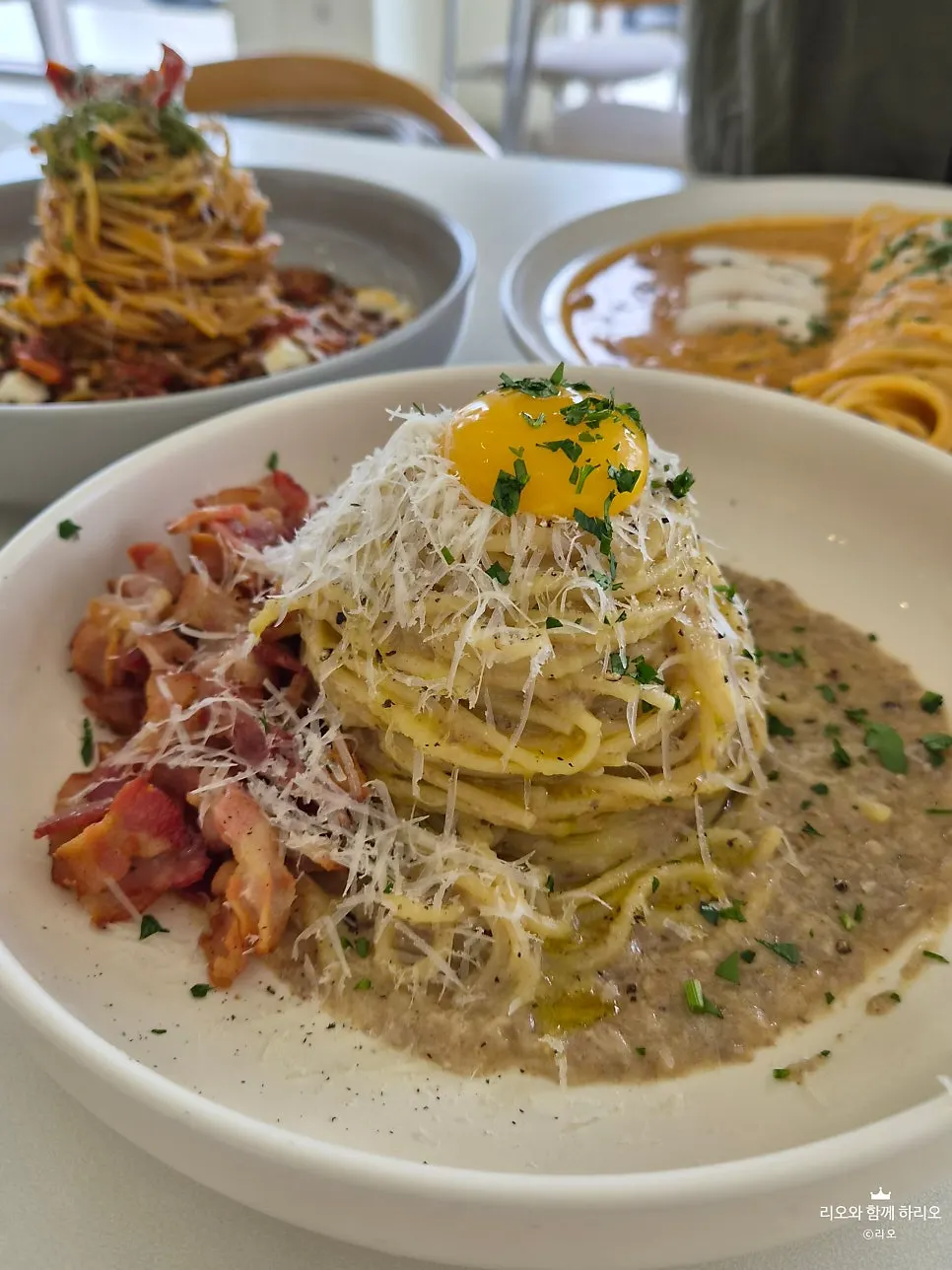 Carbonara topped with cheese and egg yolk