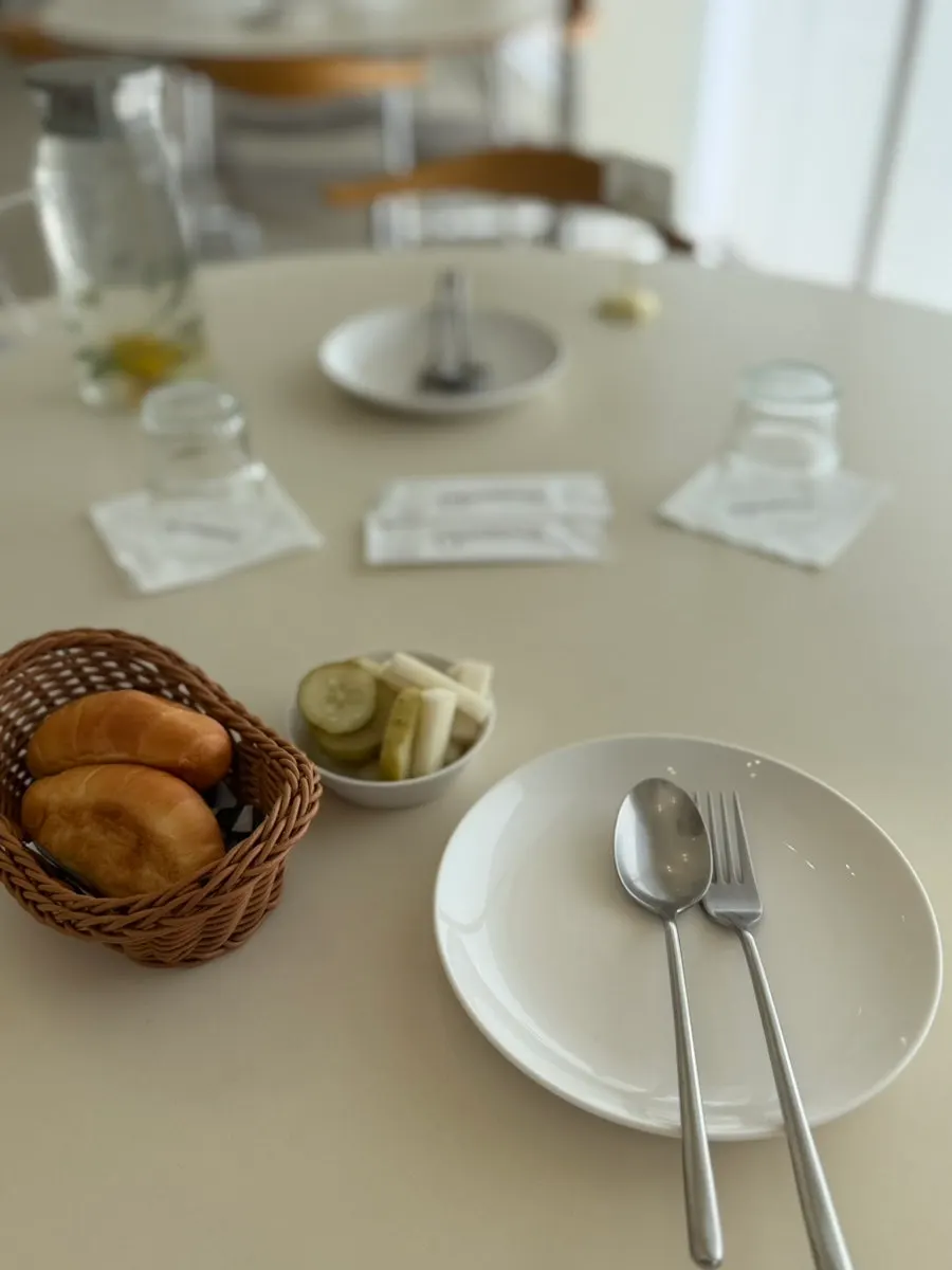 Table setting with tableware and bread course at Eoneu Dal