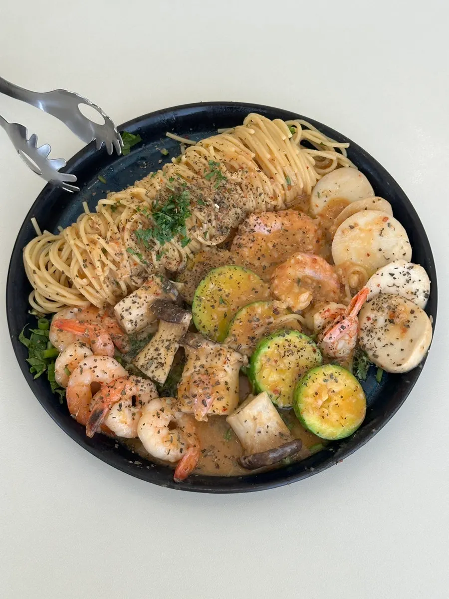 A plate of garlic shrimp pasta with bisque sauce
