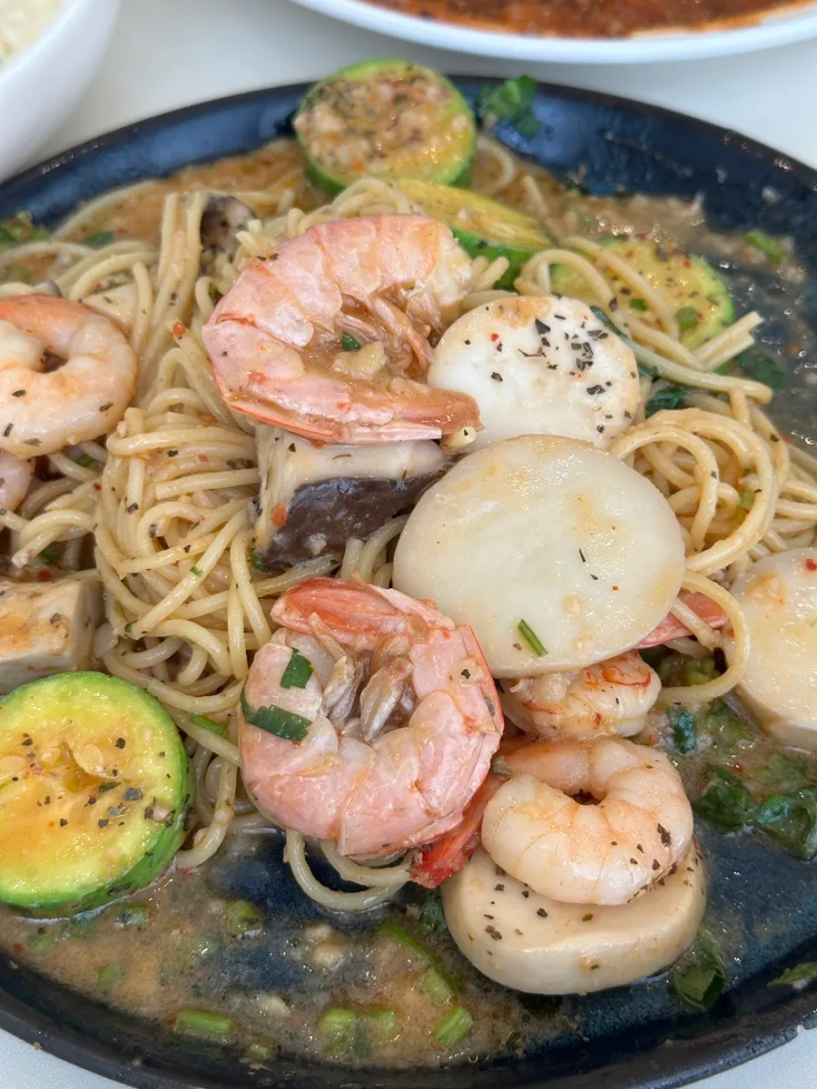 Garlic shrimp pasta noodles topped with minari