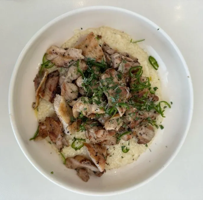 Close-up of chicken risotto topped with pepper
