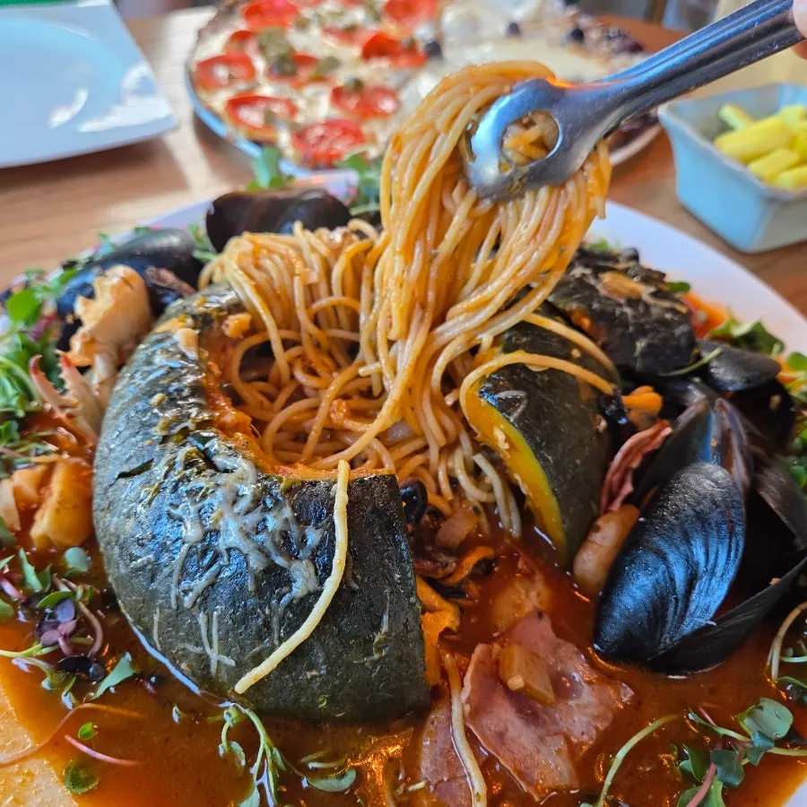 Pasta noodles inside a pumpkin cut in half