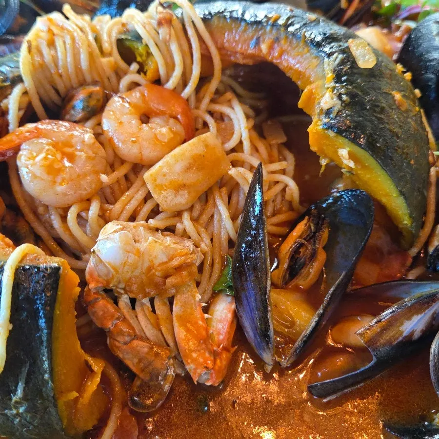 Noodles and seafood tossed in spicy tomato sauce