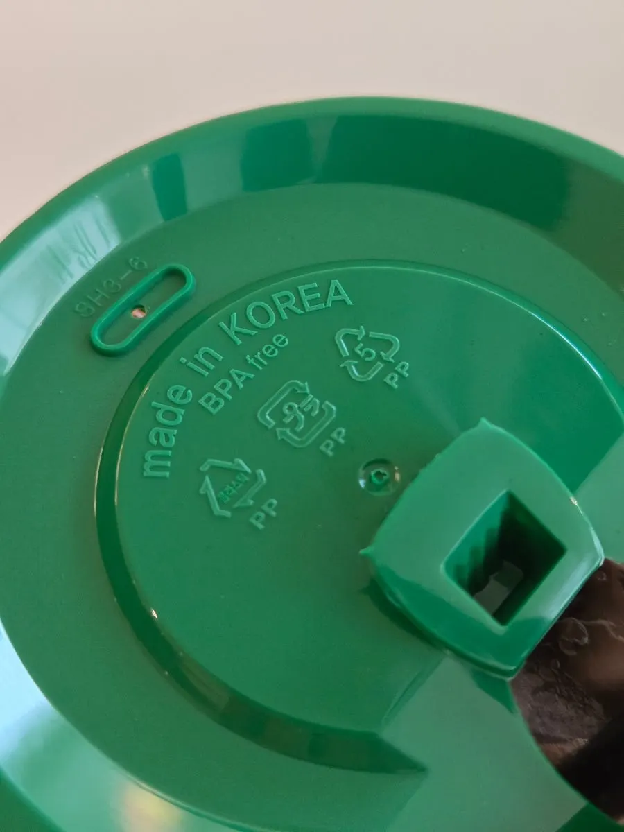 Reusable cup with a green lid
