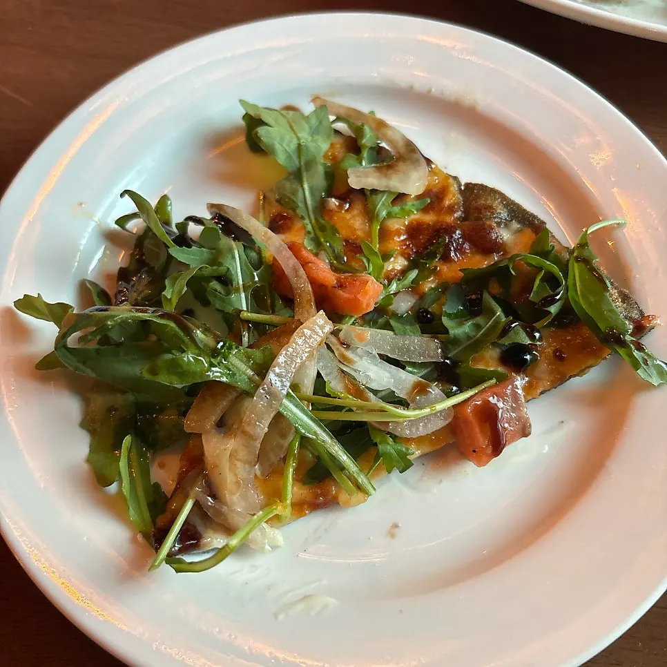 Half-and-half pizza with rocket, smoked salmon, and blueberry