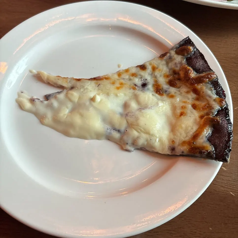 A slice of the rocket and smoked salmon pizza
