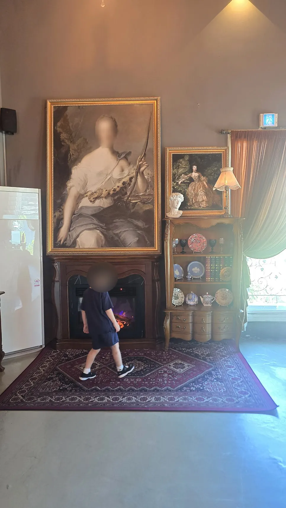 First floor space decorated with antique candlesticks and paintings