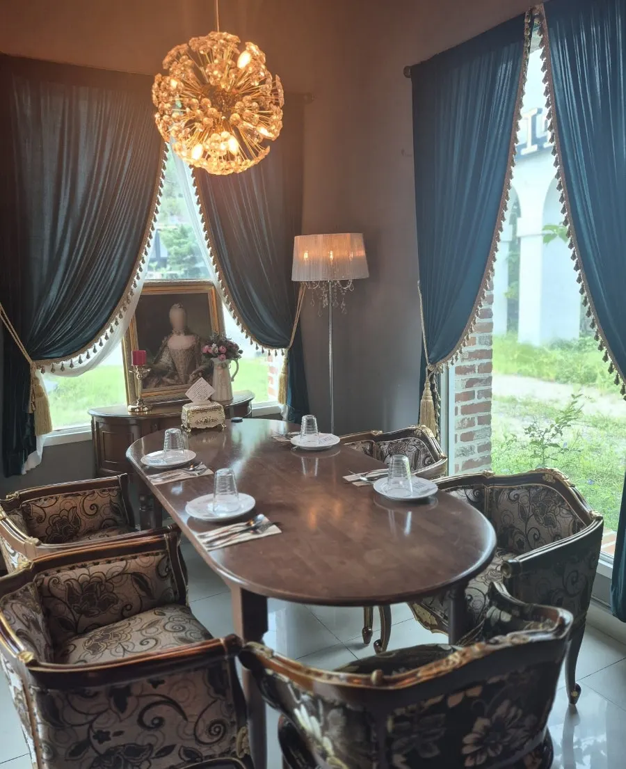 From Italy interior seating hung with classical-style paintings
