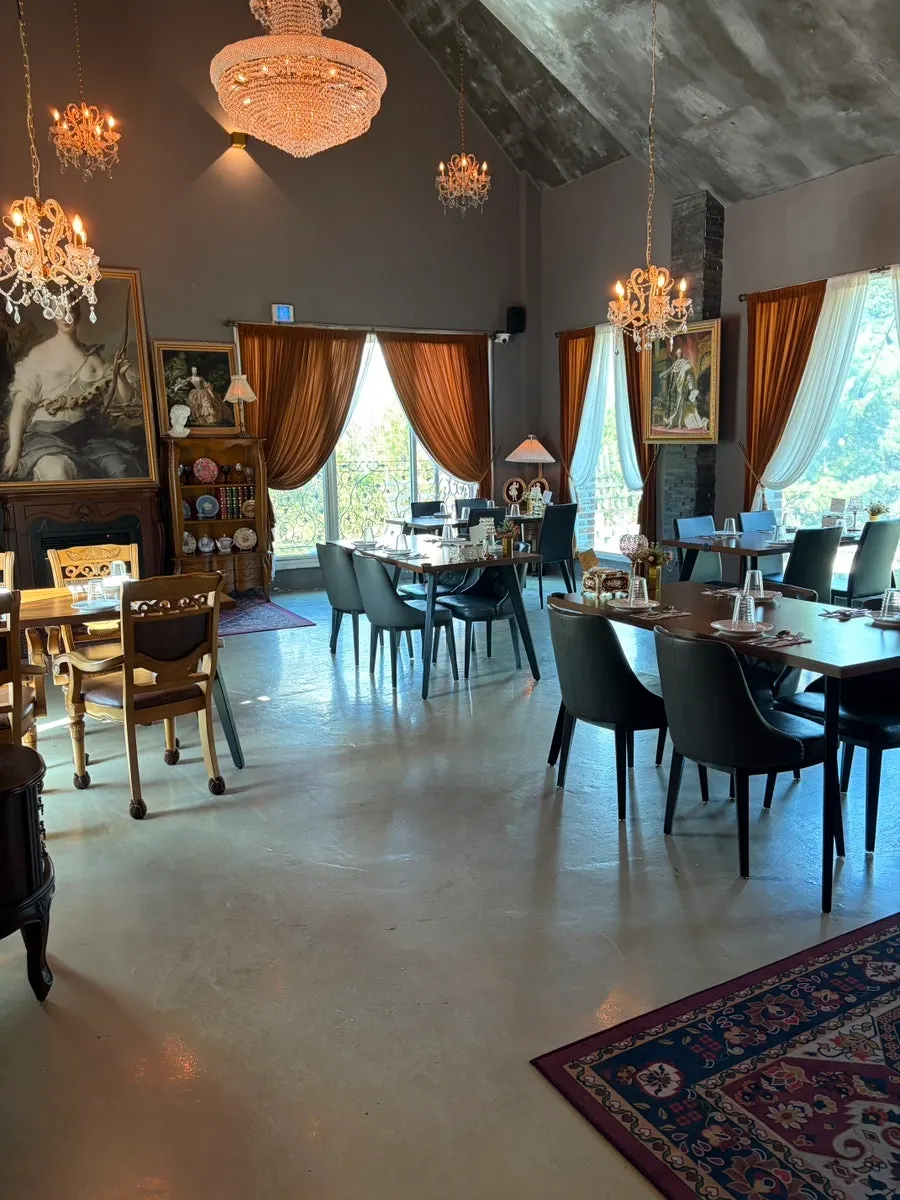 First-floor hall decorated with chandeliers and antique wooden furniture