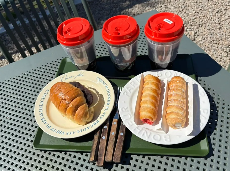 Ang-butter salt bread and coffee on an outdoor table