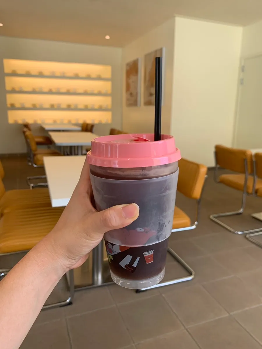 Iced americano served in a pink reusable tumbler