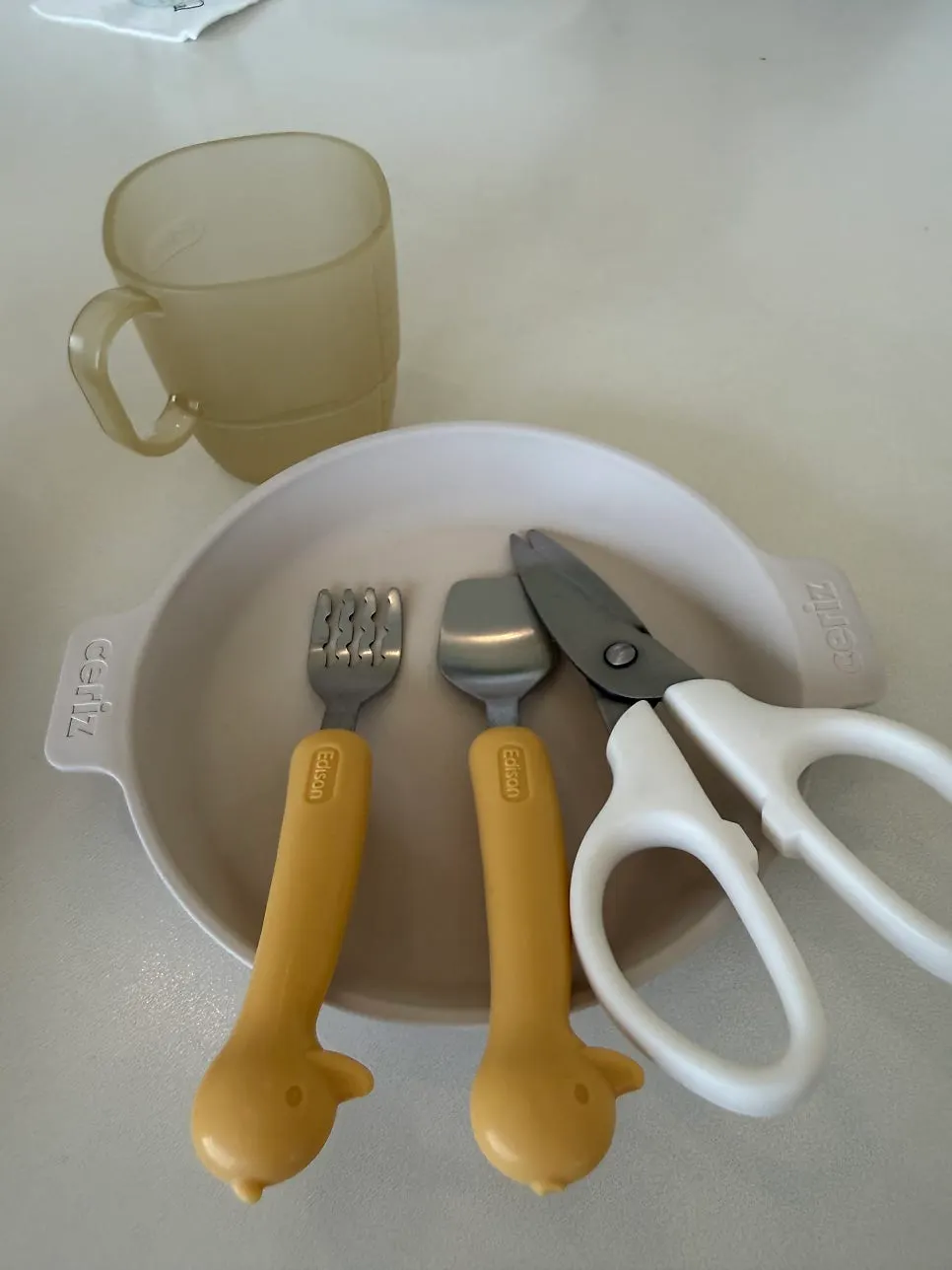 Kids' cutlery and kitchen scissors set on the table