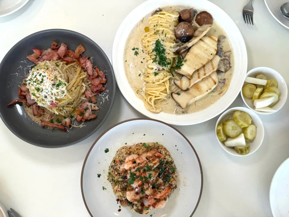 Carbonara, mushroom cream pasta and shrimp pilaf on the table