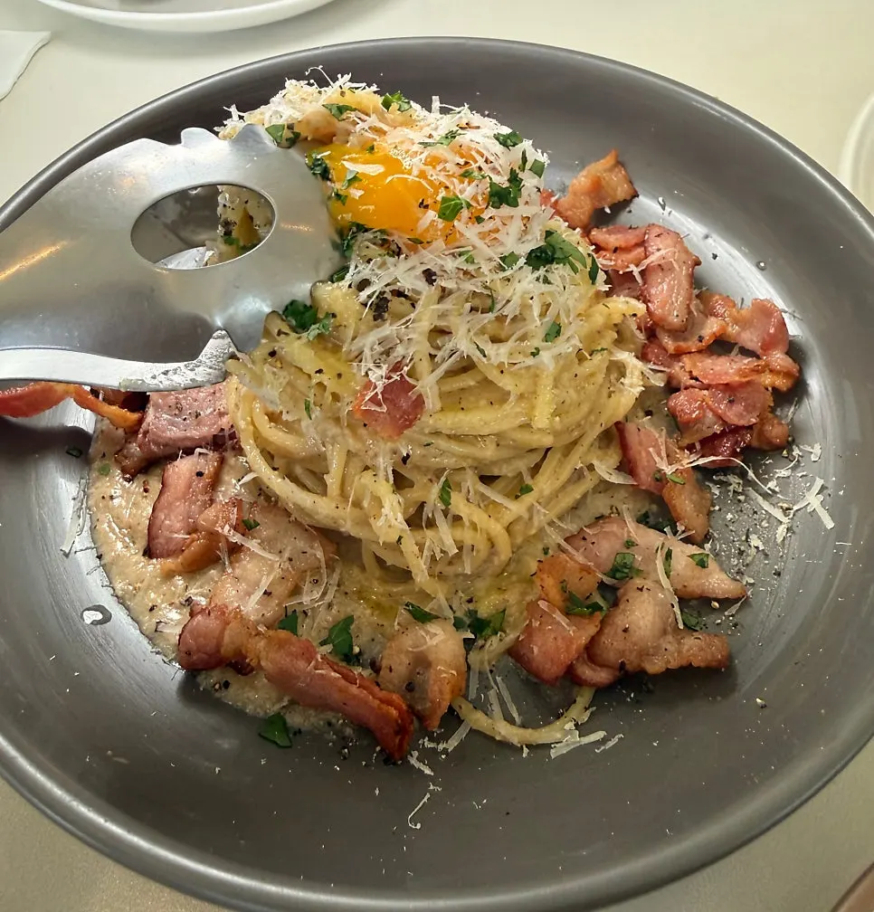 Egg yolk mixed into the carbonara noodles