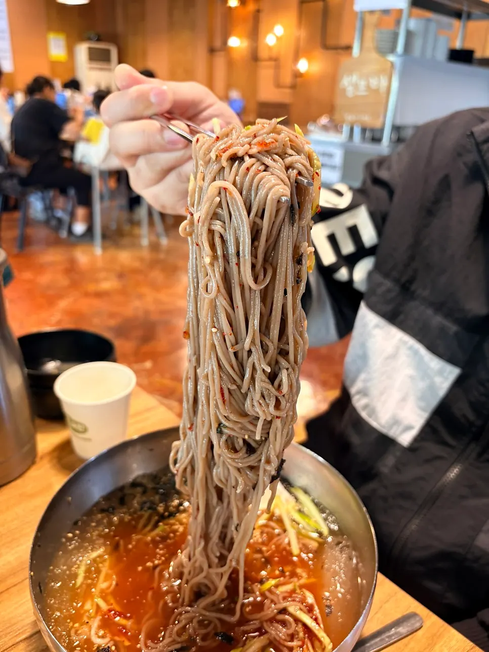 Neatly plated noodles and broth in the water makguksu