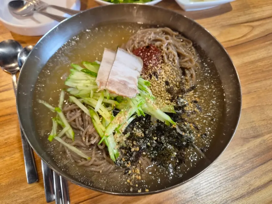 Myeongimong's basic table setting with greens and white kimchi