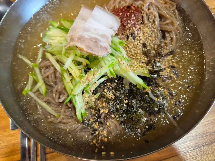Salad and side dishes on plates at Myeongimong
