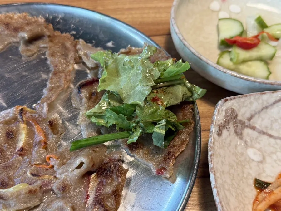 Lettuce salad placed on top of buckwheat pancake