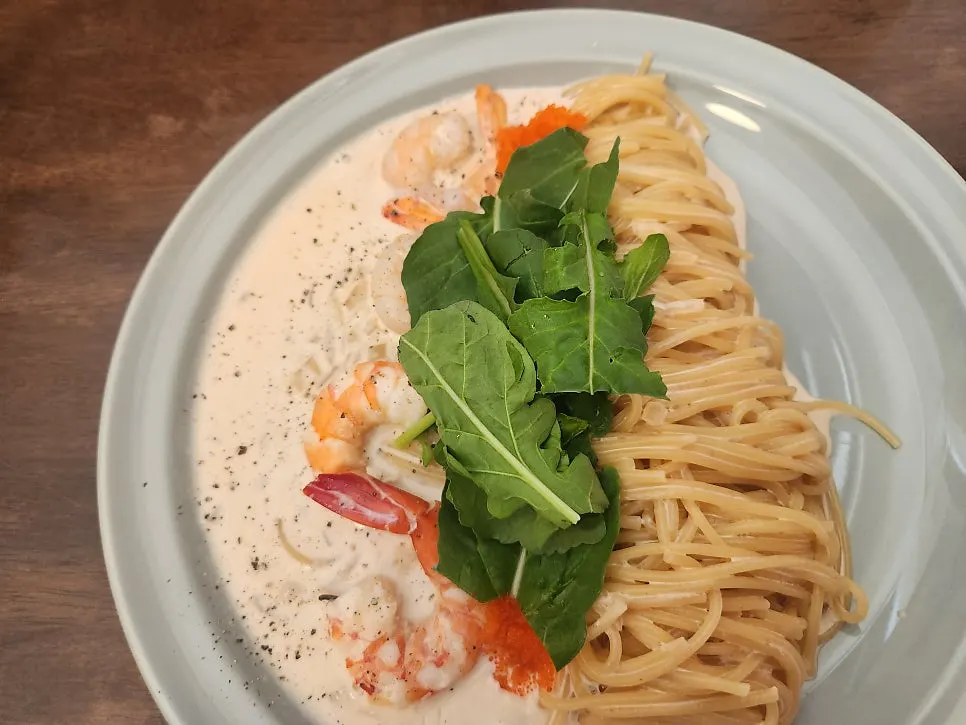Close-up of red shrimp pasta topped with flying fish roe