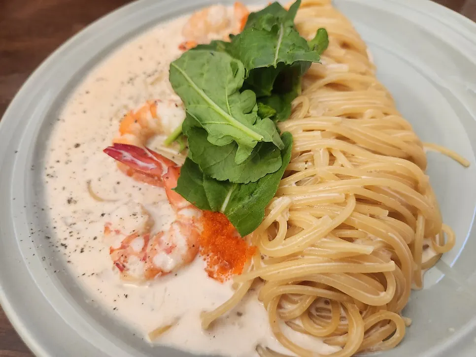 Pasta topped with big chunky red shrimp