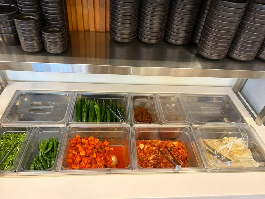 Self-serve banchan bar with side dishes neatly arranged