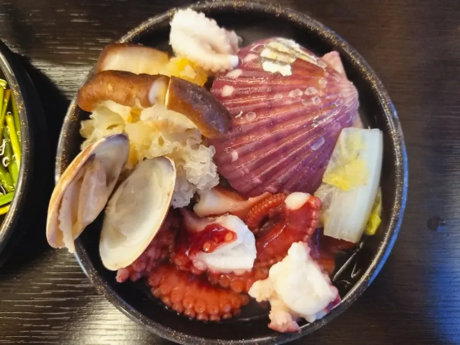 Vegetables and seafood cooking in the hot pot