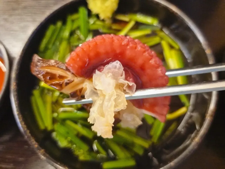 Thick octopus tentacles visible in the pot