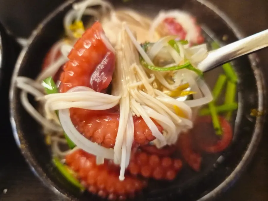 Cooked octopus and seafood plated separately