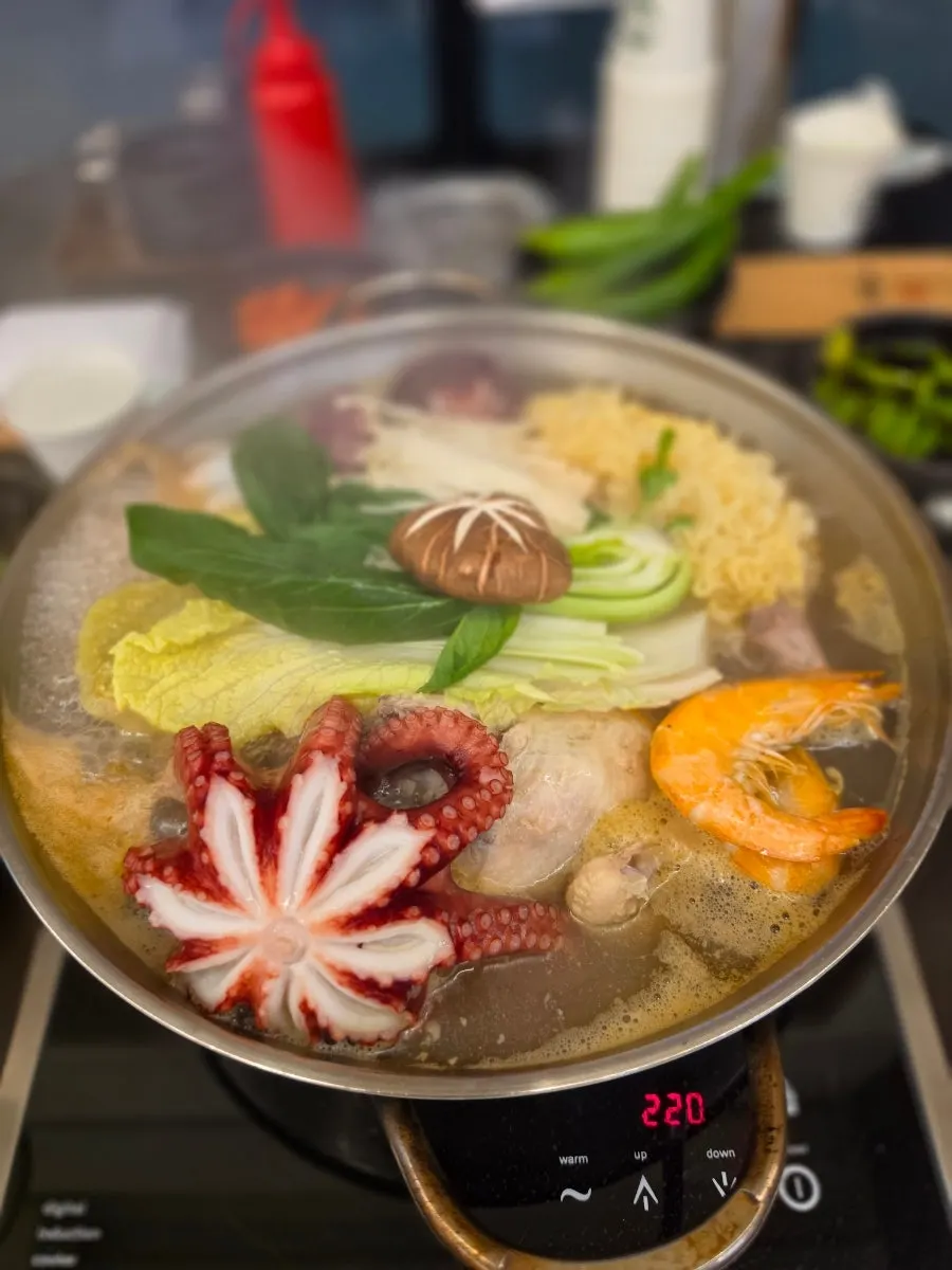 Giant octopus in the haesintang pot as it starts to boil