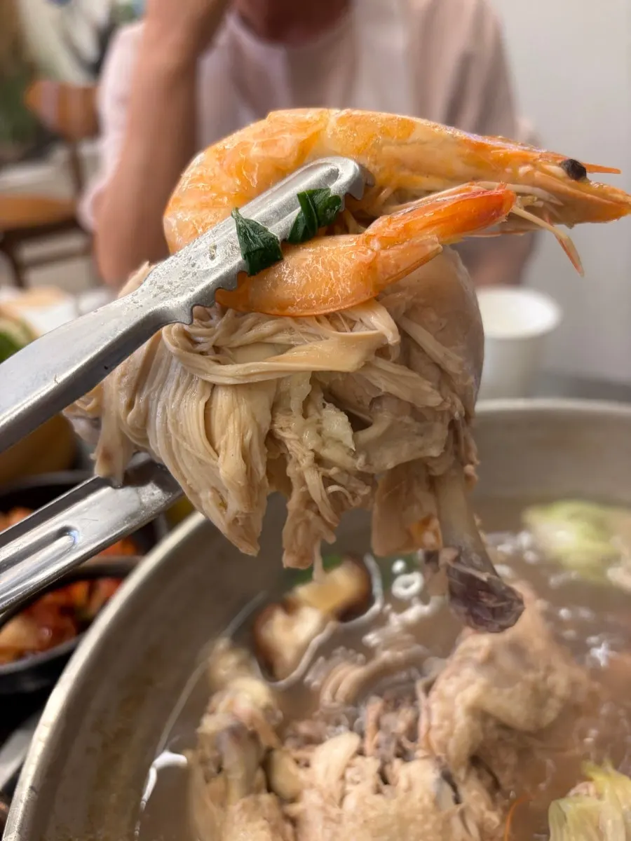 Slow-simmered chicken pulled from the bottom of the haesintang pot