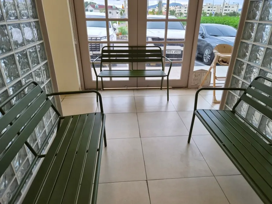 Table seating with floor-to-ceiling windows and high ceilings