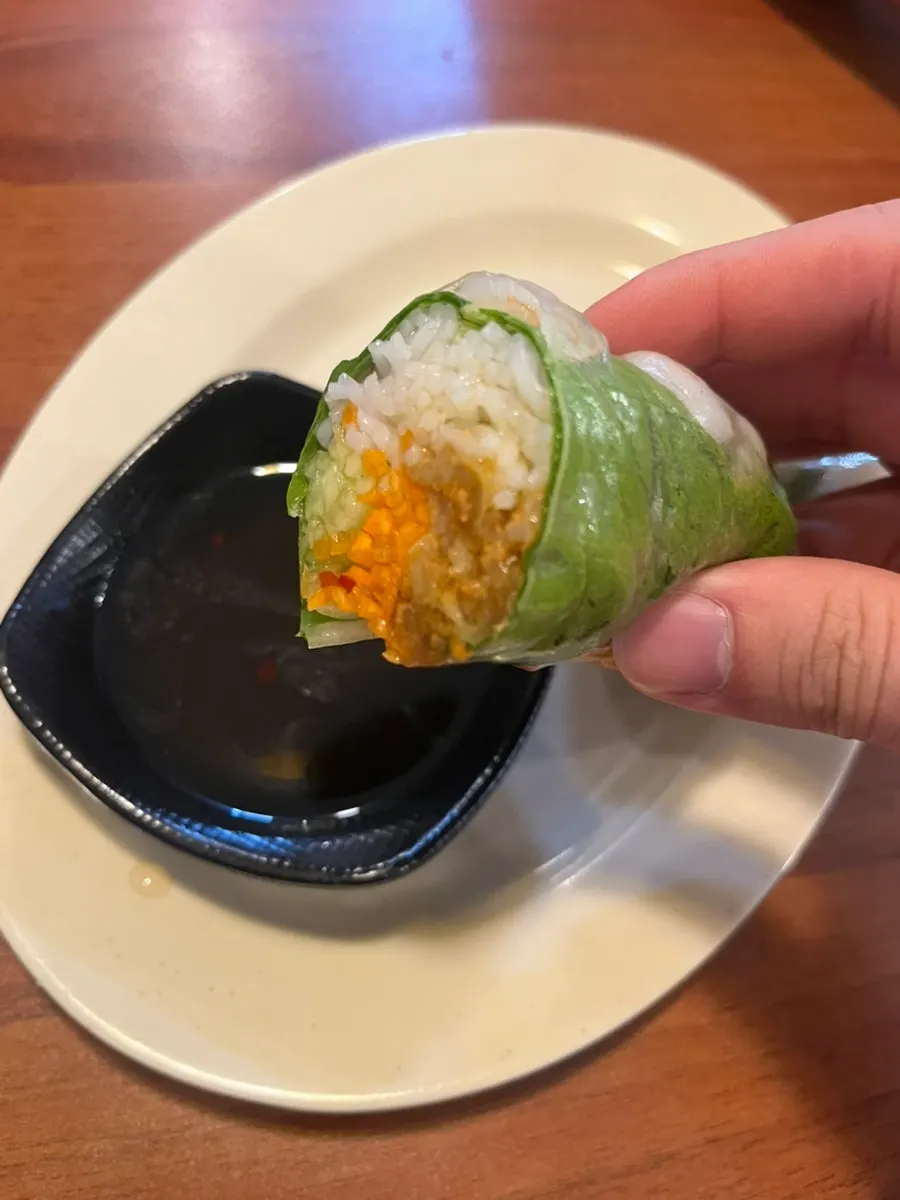Cha gio cut in half revealing meat and vegetable filling