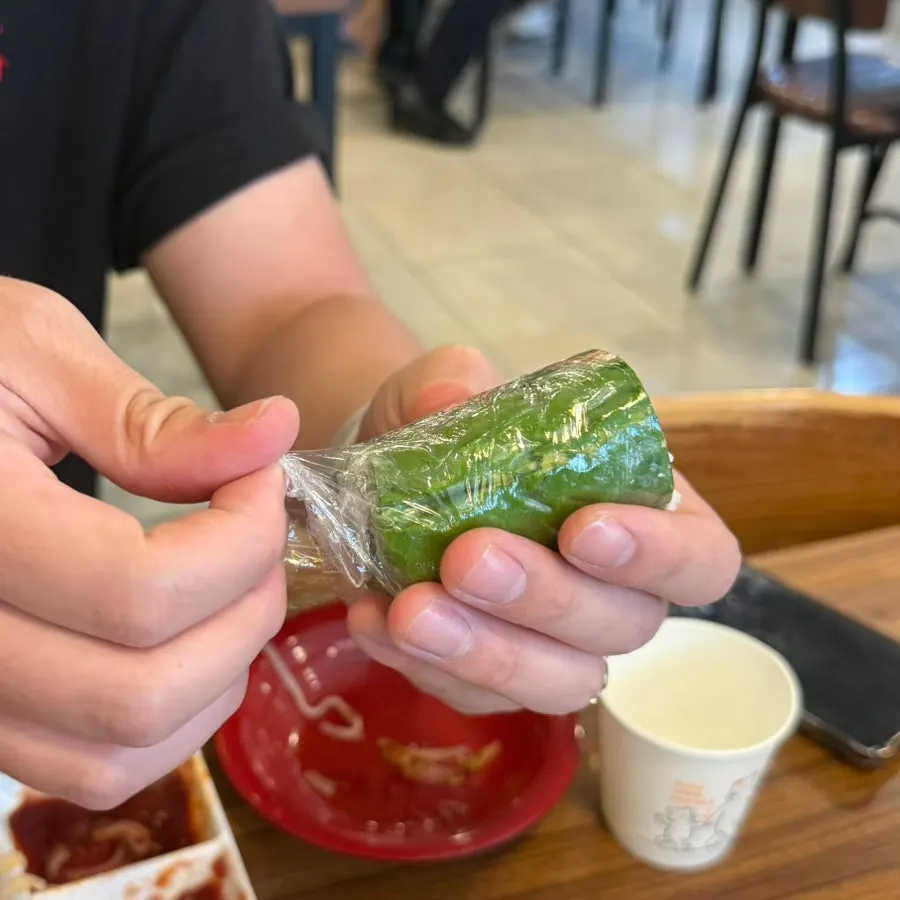 Phodam spring roll with the plastic wrap removed