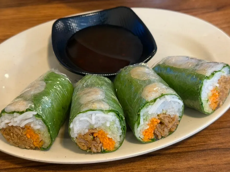 Four Phodam spring rolls served with dipping sauce
