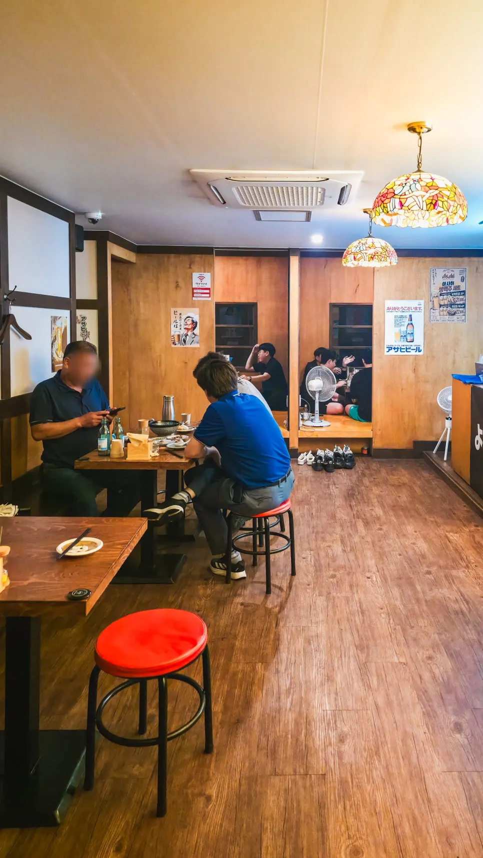 Open-kitchen dachi counter with skewers being grilled