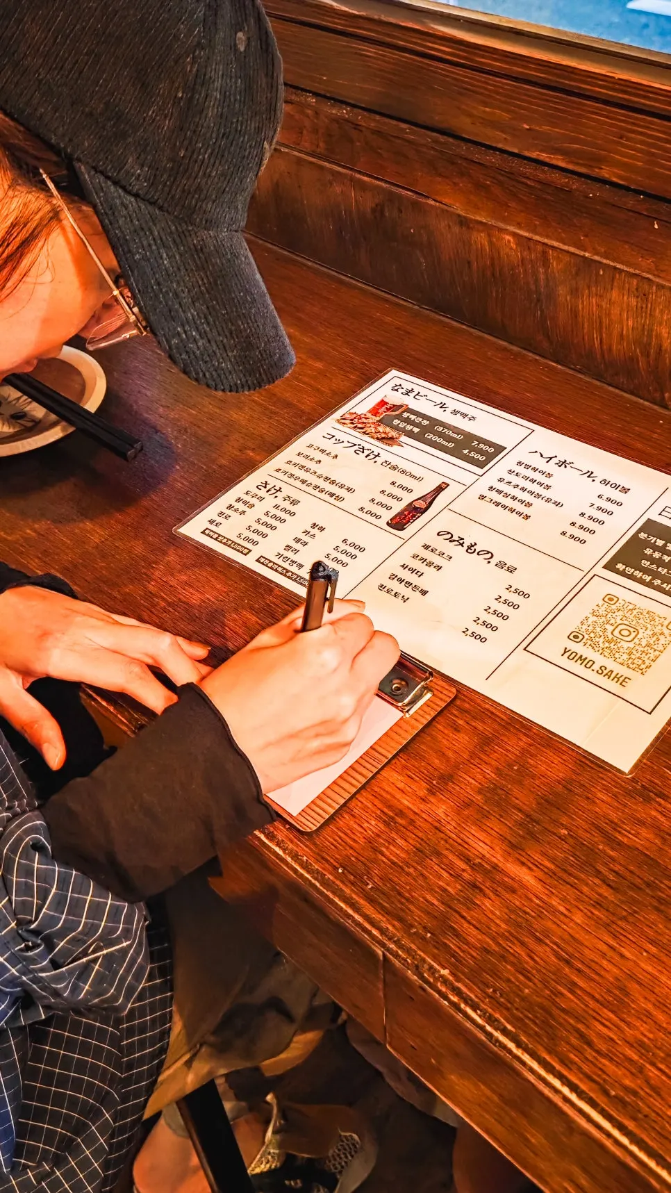 Drinks menu listing draft beer, highballs, and sake