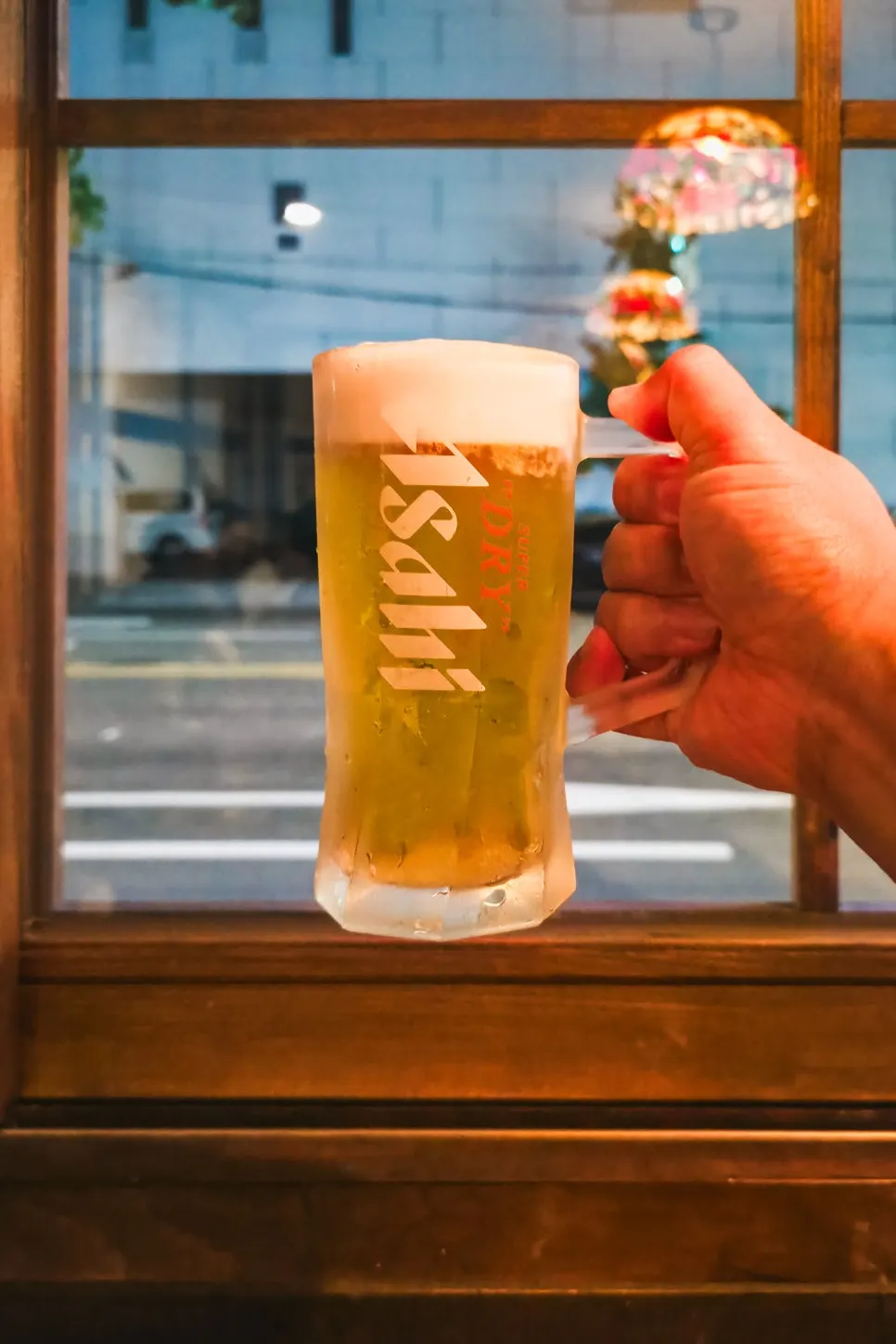 Frost-rimmed glass of Asahi draft beer and pear juice